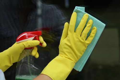 Cleaner preparing safely with cleaning supplies